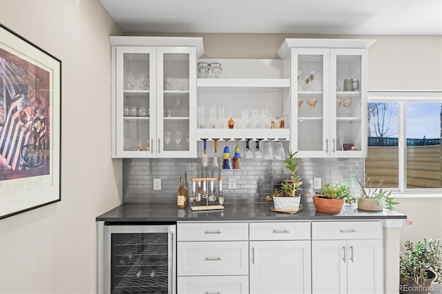 bar with a bar, wine cooler, and tasteful backsplash