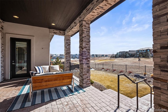 view of patio / terrace featuring an outdoor hangout area and fence