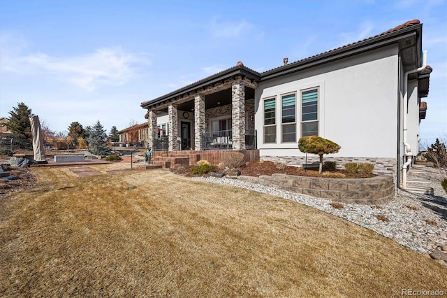 view of front of house with a front lawn and stucco siding