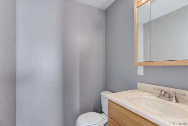 bathroom with toilet and vanity