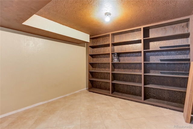 walk in closet with tile patterned floors