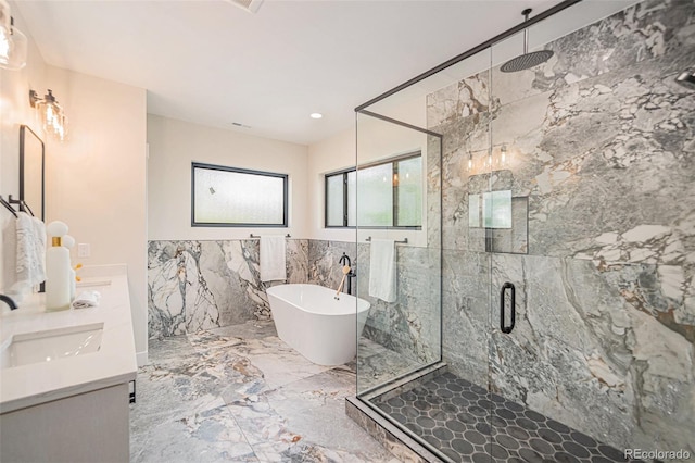 bathroom featuring vanity, tile walls, and separate shower and tub