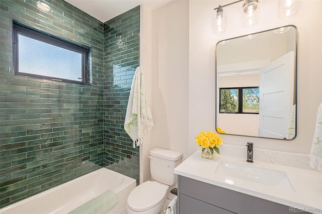 full bathroom with vanity, plenty of natural light, toilet, and tiled shower / bath