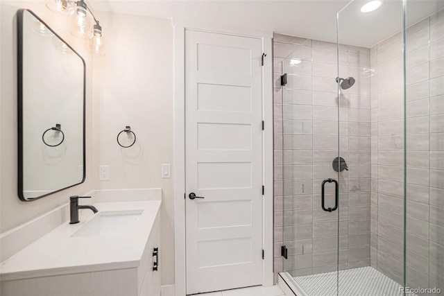 bathroom featuring tile patterned flooring, vanity, and an enclosed shower