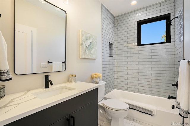 full bathroom with toilet, tiled shower / bath combo, vanity, and tile patterned flooring