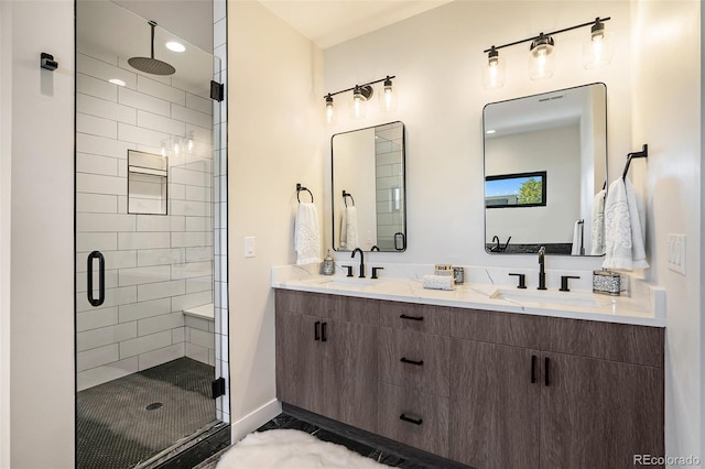 bathroom with vanity and a shower with door