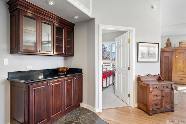 bar featuring light wood finished floors and baseboards