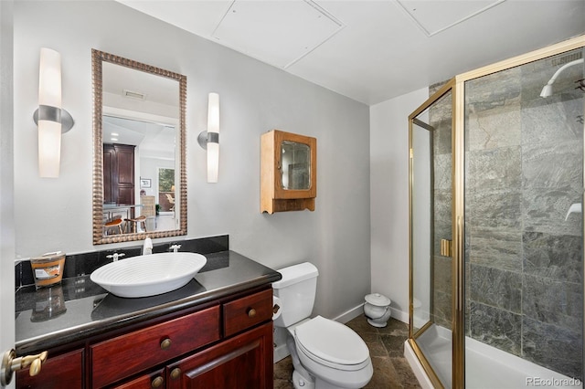 bathroom with a stall shower, visible vents, baseboards, toilet, and vanity