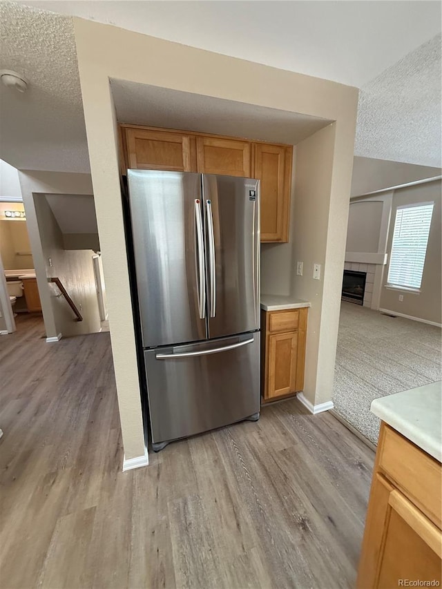 23760 Broadmoor Dr, Parker, CO 80138 - kitchen featuring freestanding refrigerator, a textured ceiling, light wood-style flooring, and baseboards