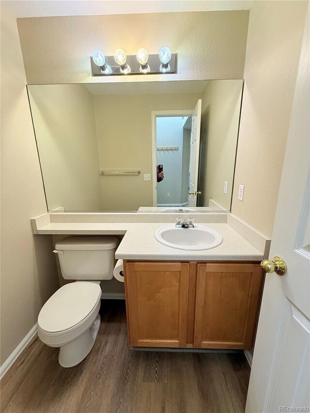 23760 Broadmoor Dr, Parker, CO 80138 - bathroom with wood finished floors, vanity, toilet, and baseboards
