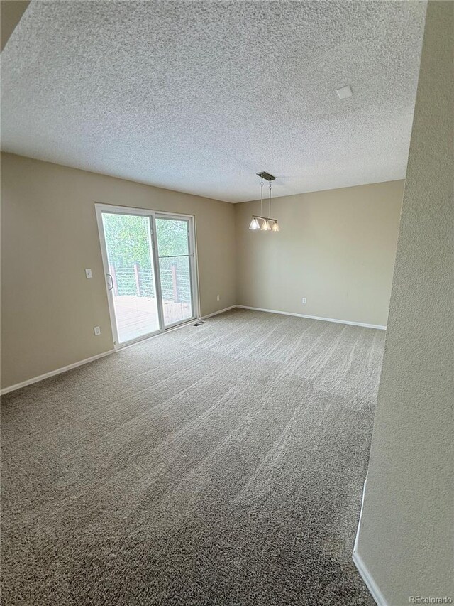 23760 Broadmoor Dr, Parker, CO 80138 - spare room featuring a textured ceiling, carpet floors, and baseboards