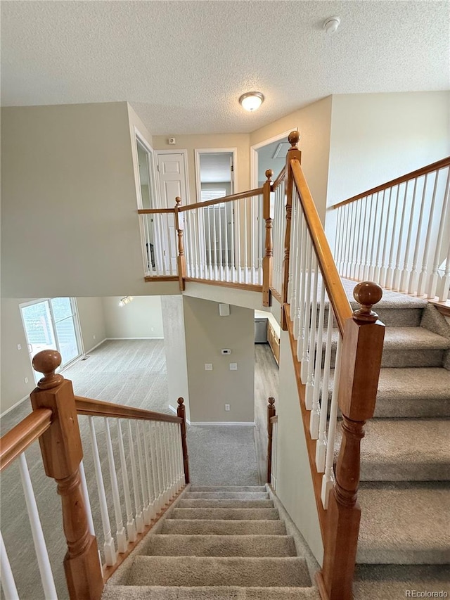 23760 Broadmoor Dr, Parker, CO 80138 - staircase with carpet flooring, a textured ceiling, and baseboards