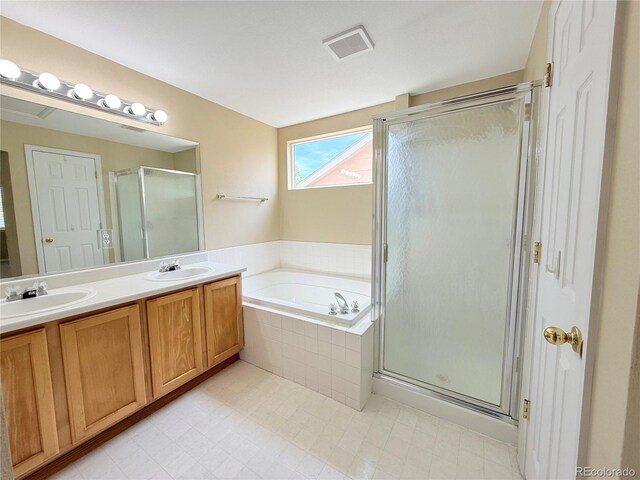 23760 Broadmoor Dr, Parker, CO 80138 - full bathroom featuring a bath, double vanity, a shower stall, and tile patterned flooring