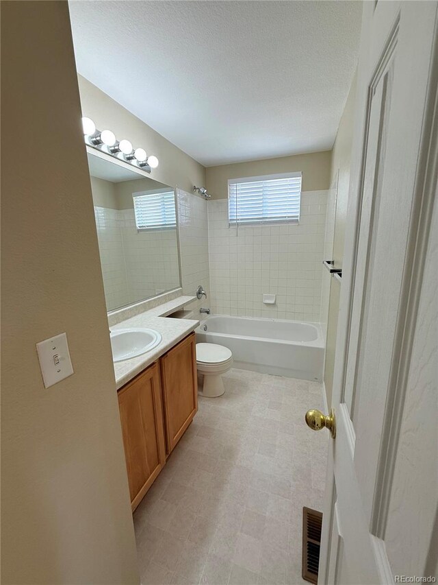 23760 Broadmoor Dr, Parker, CO 80138 - bathroom featuring toilet, vanity, shower / bath combination, and a textured ceiling
