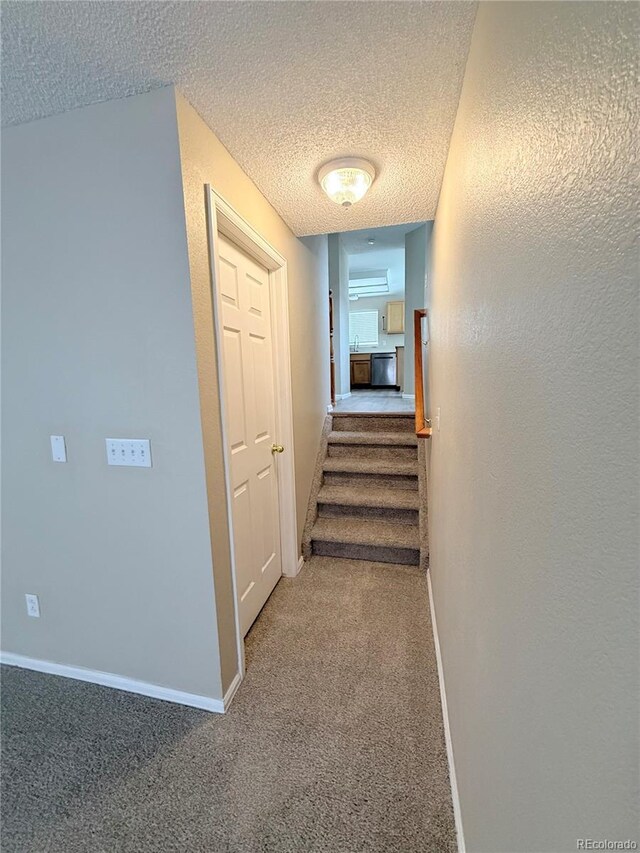23760 Broadmoor Dr, Parker, CO 80138 - hallway with a textured ceiling, baseboards, carpet floors, stairs, and a sink
