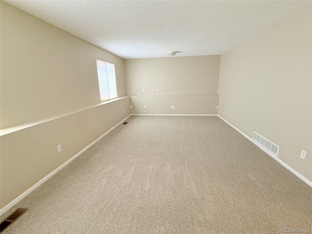 23760 Broadmoor Dr, Parker, CO 80138 - spare room featuring light carpet, a textured ceiling, and baseboards