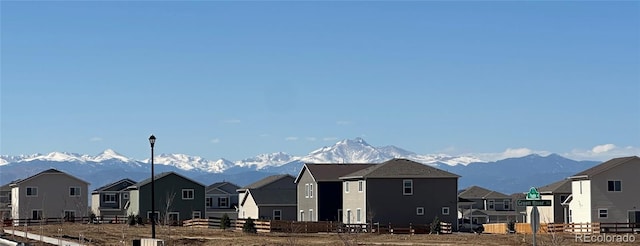 view of outdoor structure featuring a residential view and a mountain view