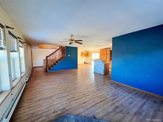 spare room featuring ceiling fan, a baseboard radiator, and dark hardwood / wood-style floors