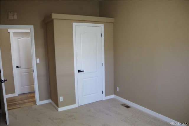 179 13th Ave, Cedaredge, CO 81413 - unfurnished bedroom featuring visible vents, baseboards, and light carpet