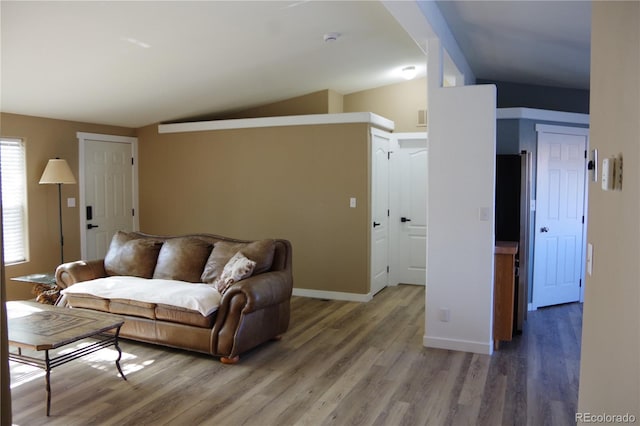 179 13th Ave, Cedaredge, CO 81413 - living room featuring lofted ceiling, light wood-style flooring, and baseboards