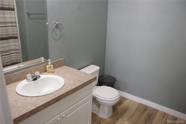 179 13th Ave, Cedaredge, CO 81413 - full bathroom featuring toilet, baseboards, curtained shower, vanity, and wood finished floors