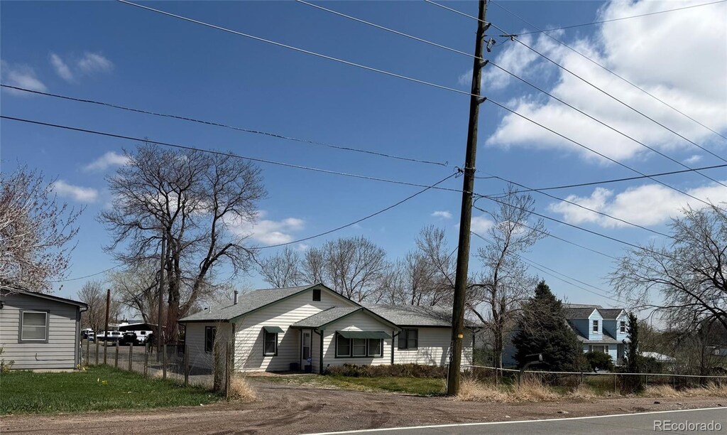 7750 Indiana St, Arvada, CO 80007 - view of front of house with fence and dirt driveway