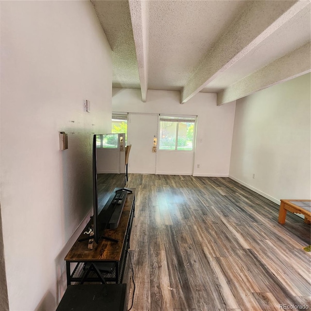 384 S Ironton St Unit 102, Aurora, CO 80012 - unfurnished living room with a textured ceiling, beamed ceiling, and wood finished floors
