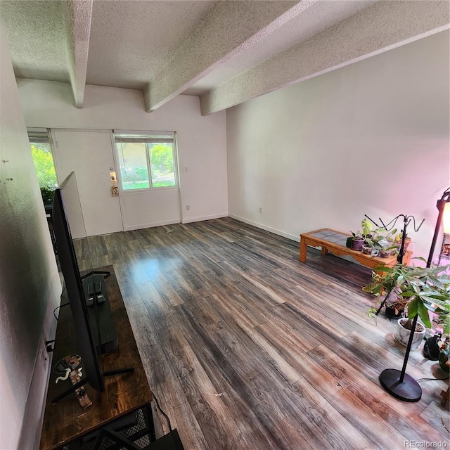384 S Ironton St Unit 102, Aurora, CO 80012 - unfurnished living room with a textured ceiling, beamed ceiling, and wood finished floors