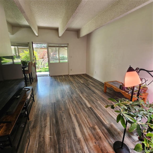 384 S Ironton St Unit 102, Aurora, CO 80012 - living room with a textured ceiling, beamed ceiling, and wood finished floors