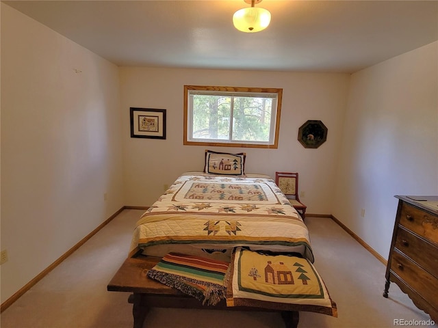 bedroom with light carpet and baseboards