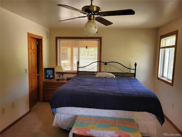 bedroom with baseboards, a ceiling fan, and carpet