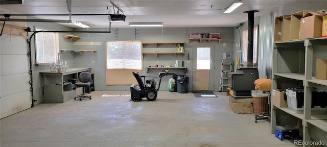 garage featuring a garage door opener and a wood stove