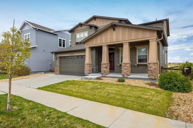 14807 Haley Ave, Parker, CO 80134 - craftsman house with covered porch, driveway, a front lawn, and stone siding