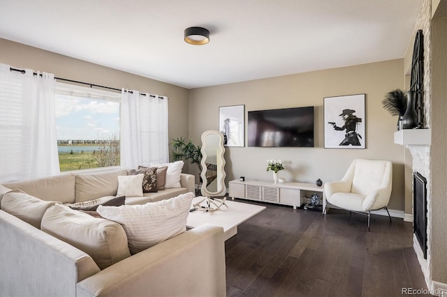 14807 Haley Ave, Parker, CO 80134 - living room featuring a fireplace, baseboards, and dark wood-style floors