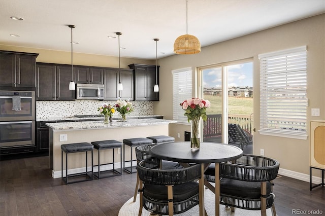14807 Haley Ave, Parker, CO 80134 - dining room featuring dark wood-style flooring, baseboards, and recessed lighting