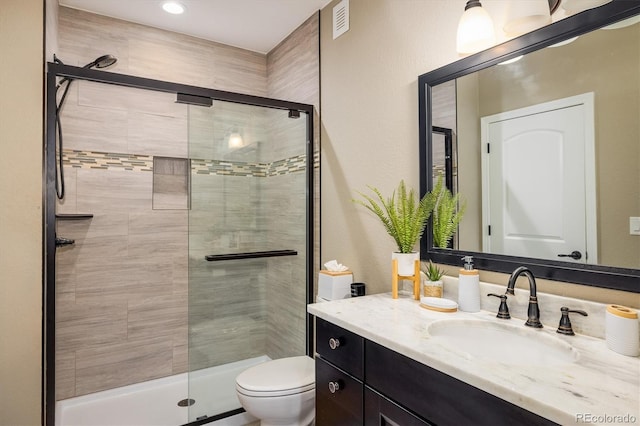14807 Haley Ave, Parker, CO 80134 - full bath featuring vanity, toilet, a shower stall, and visible vents