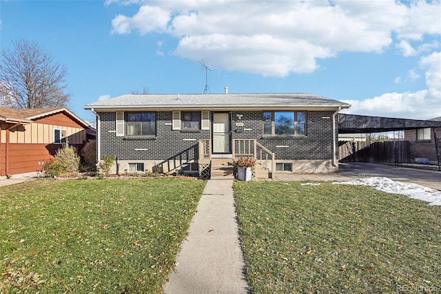 view of front of home with a front yard and a carport