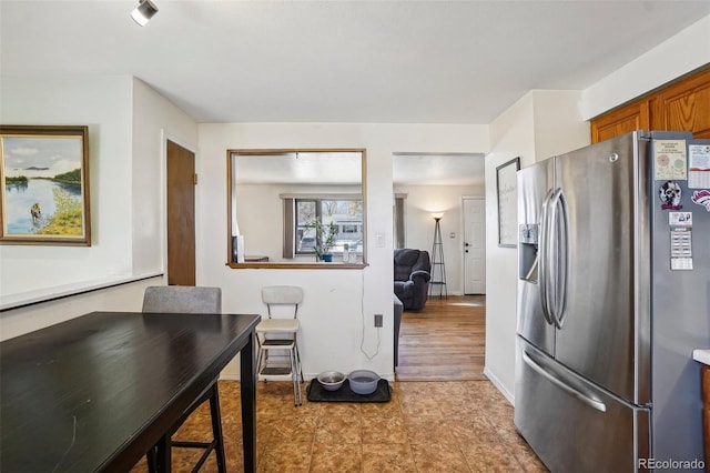 kitchen with stainless steel fridge and light hardwood / wood-style flooring