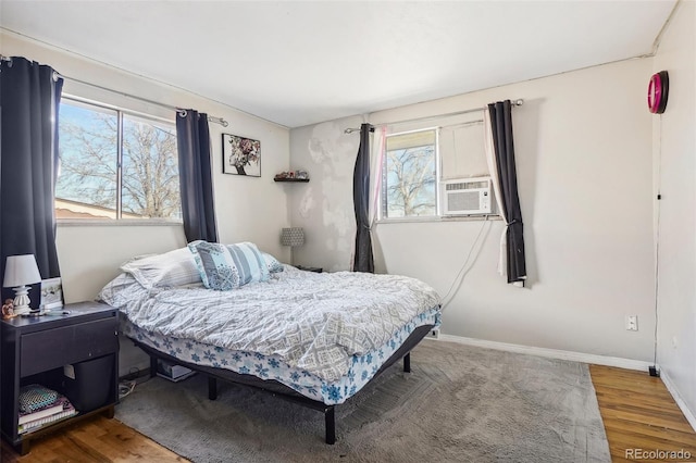 bedroom featuring hardwood / wood-style floors and cooling unit