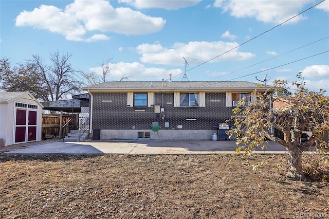 back of house featuring a patio area and a storage unit