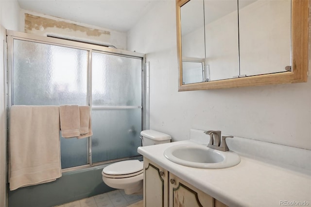 full bathroom with vanity, toilet, and bath / shower combo with glass door