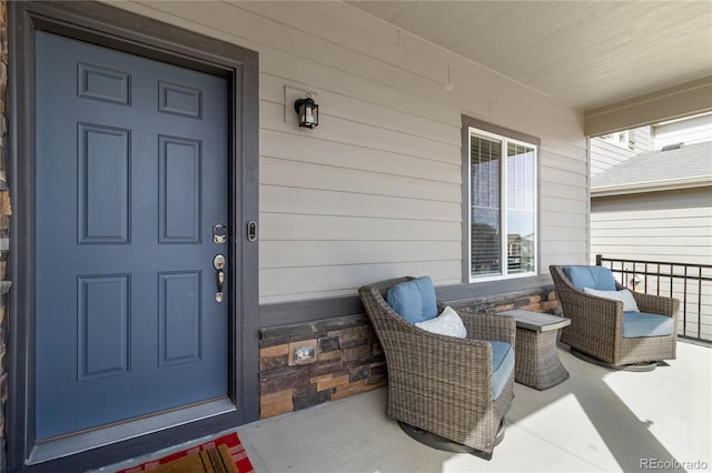 view of exterior entry featuring covered porch