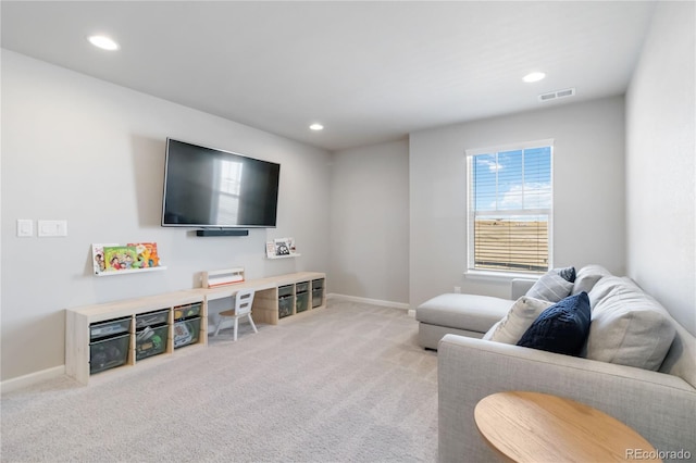 living room with recessed lighting, visible vents, baseboards, and light colored carpet