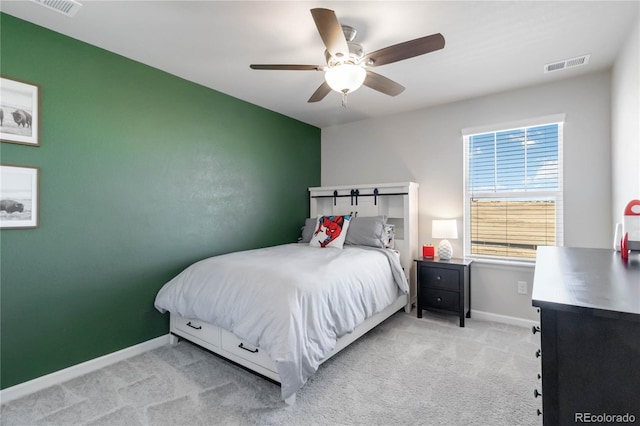 carpeted bedroom featuring baseboards, visible vents, and ceiling fan