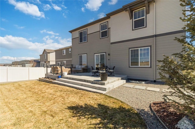 back of house featuring a patio, fence, a lawn, and an outdoor living space