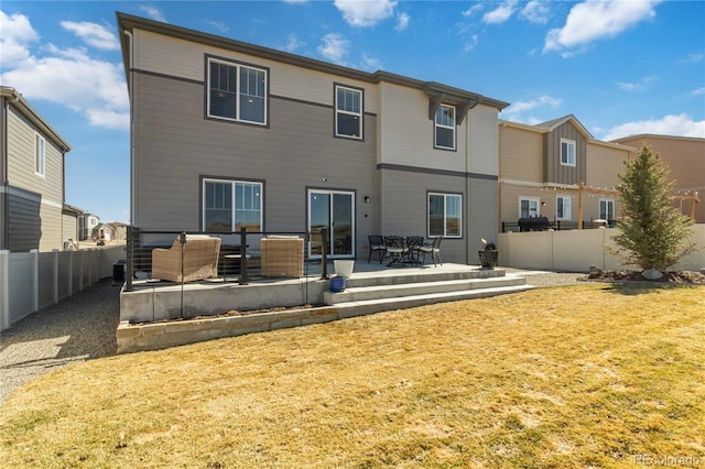 rear view of house featuring a patio area, an outdoor hangout area, and a fenced backyard