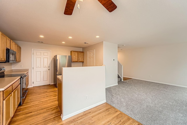 5522 S Quemoy Cir, Aurora, CO 80015 - kitchen with appliances with stainless steel finishes, a ceiling fan, recessed lighting, light wood-style floors, and light countertops
