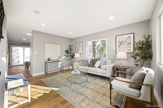 living room with baseboards, recessed lighting, and wood finished floors