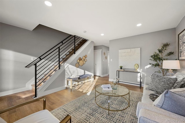 living room featuring recessed lighting, baseboards, stairs, and wood finished floors