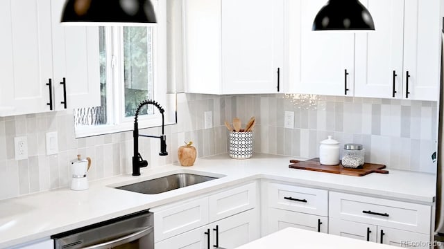 kitchen with a sink, decorative backsplash, dishwasher, and white cabinetry